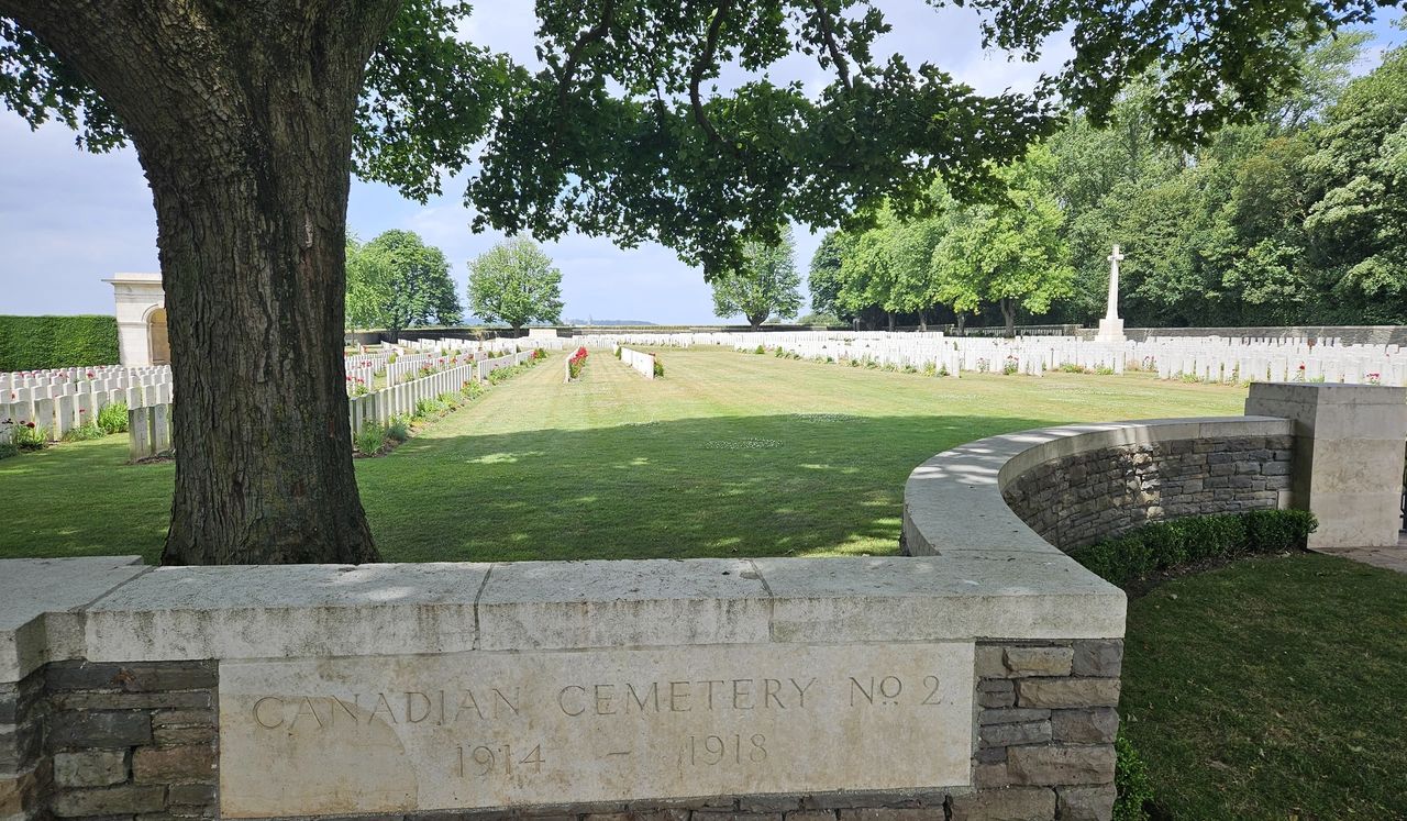 Rows and rows of headstones behind a brinck wall. Canadian cemetery No. 2 at Vimy Ridge