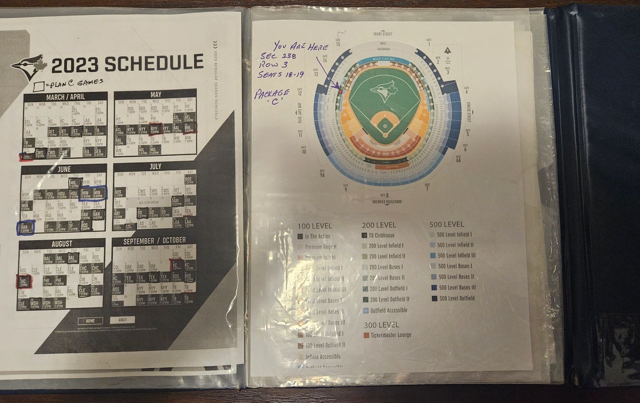 The Blue Folder.: open, with the 2023 Toronto BlueJays schedule on the left, and the dome seating plan on the right.