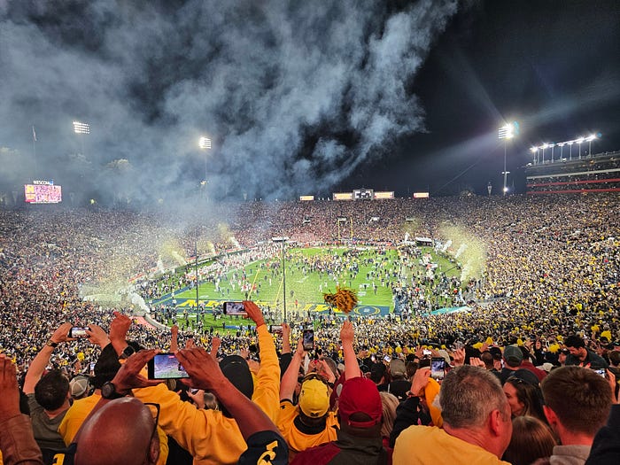 Michigan fans celebrate their victory. The crowd cheers at the Rose Bowl.