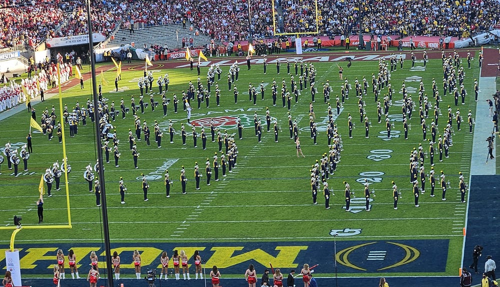 Michigan band on the field performing during halftime. 