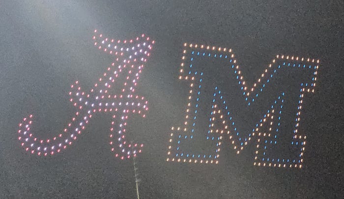 A large A in red and white and a large M in blue and yellow light up the sky.