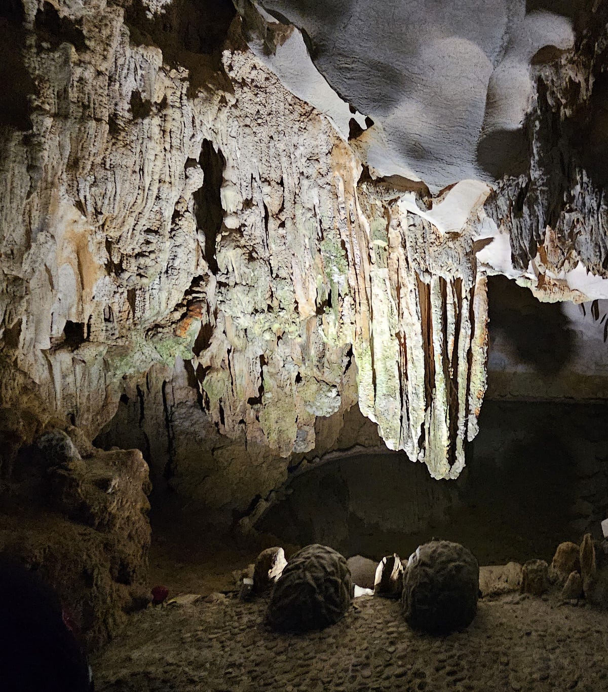 Lights illuminate the rock and stalagmites in the caves at Ha Long Bay