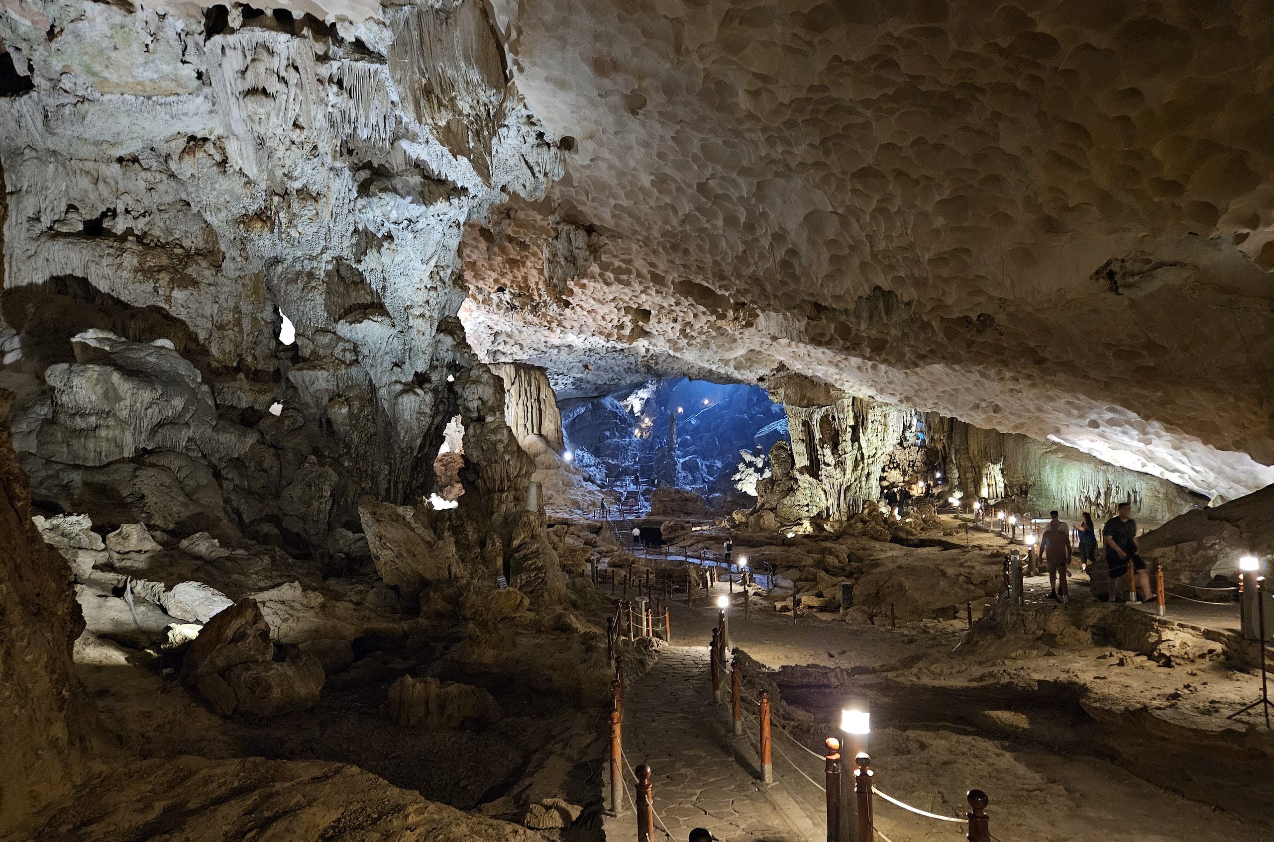 People follow a path through the Sang Hung Sot Cave in Ha Long Bay, Vietnam