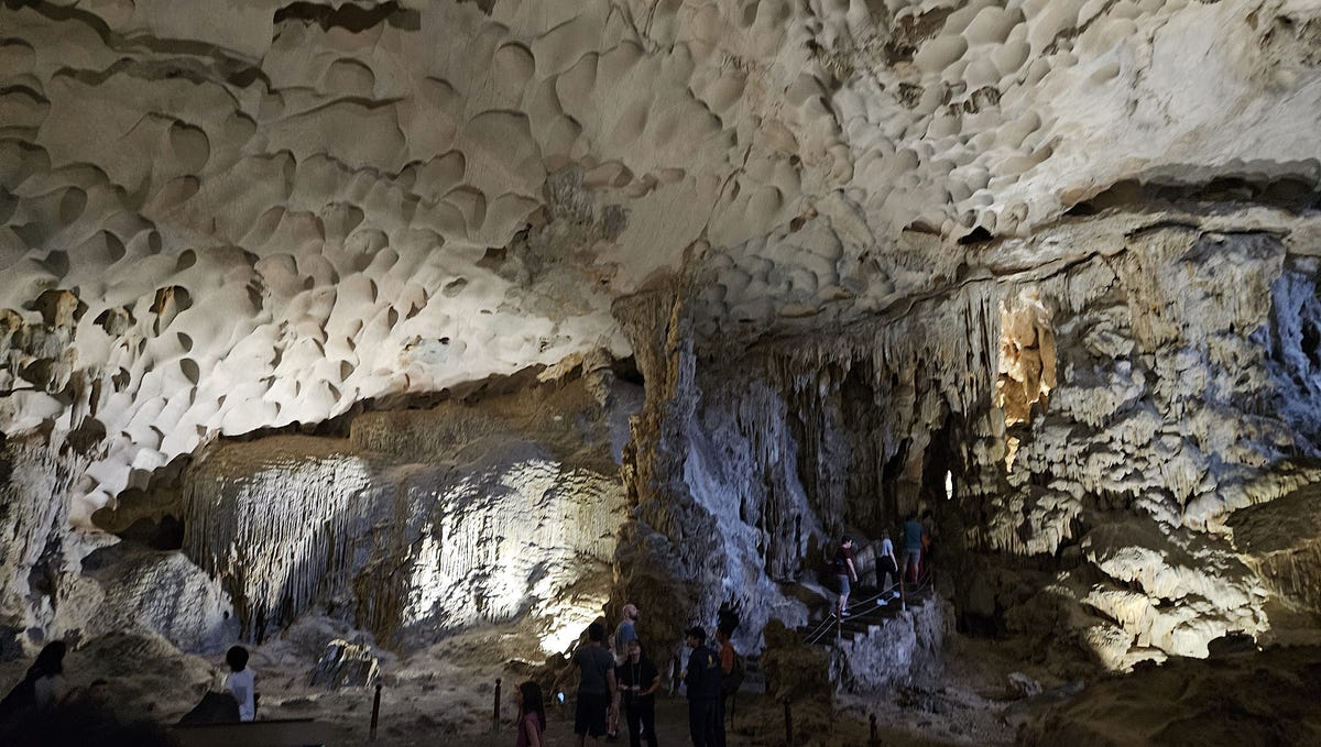 Lights illuminate the rock and stalagmites in the caves at Ha Long Bay