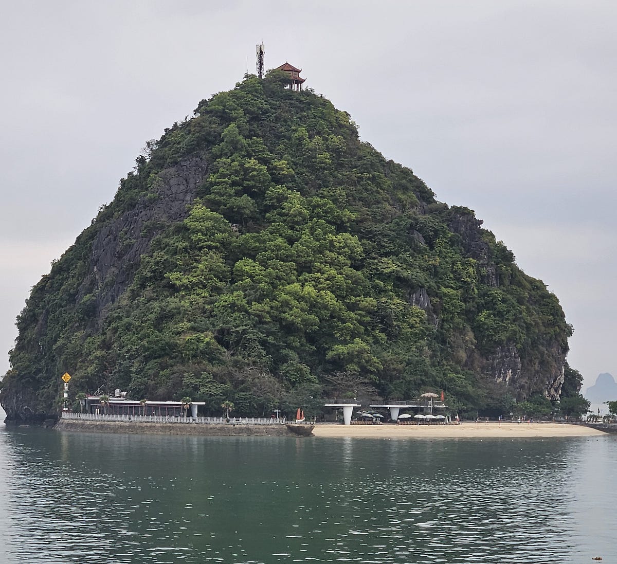 A beach at the bottom of a large Karst in Ha Long Bay, Vietnam