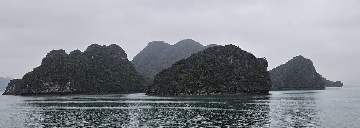 Karsts, limestone mountains, rise hundreds of feet from the sea in Ha Long Bay, Vietnam