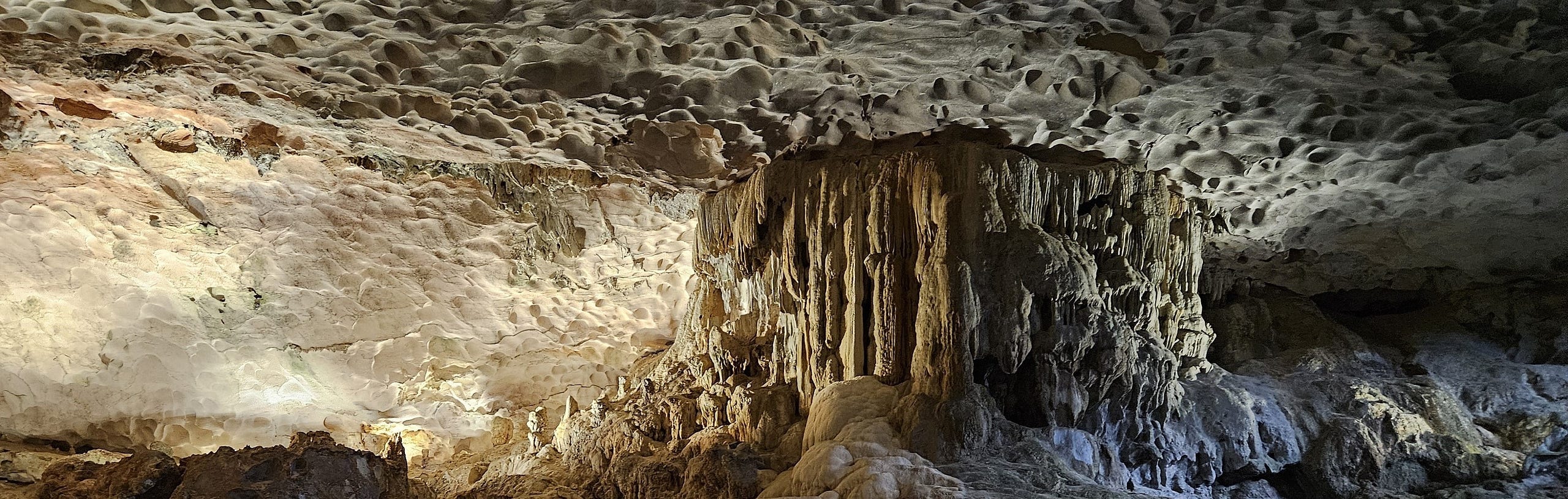 A deep and wide cave 4 stories high