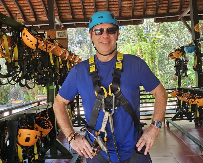 Me strapped into my harness in a room of safety gear.