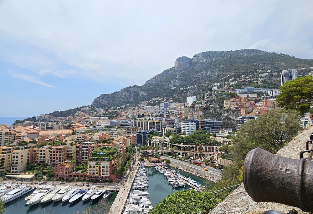 Monaco. Buildings and condos on a mountain rise from the marina